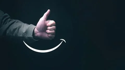 Close-up of hand giving thumbs up gesture with smile symbol Stock Photos