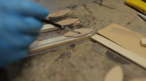 Close up on hand with gloves, gluing plastic with paintbrush Stock Footage 60986069