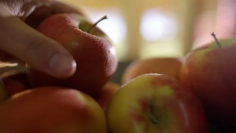 Close up of a hand grabbing a dewy red apple in kitchen. Stock Footage 142845898
