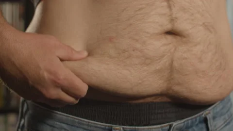 Close up of hand grabbing love handle of fat shirtless man Vidéo 196920522