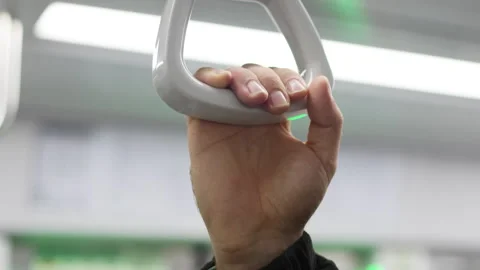 Close up hand grasps clean white handle. Focus highlights human interaction with Stock Footage 323057893