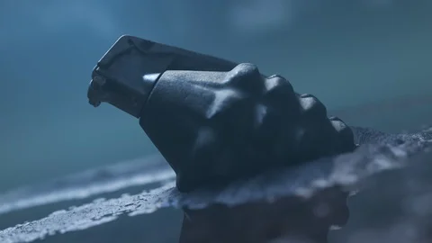 Close up of a hand grenade lying in the mud. Bright explosion at the end. 4K HD Stock Footage 119988615