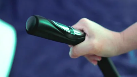 Close-up of a hand gripping and moving the handle of an exercise machine 스톡 동영상 336010234