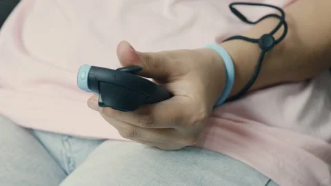 Close up hand gripping Nintendo Switch 2 gaming controller, wrist strap visible, Stock Footage 312433262