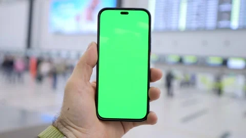 Close-up of hand gripping phone with blank green display Stock Footage 343568122