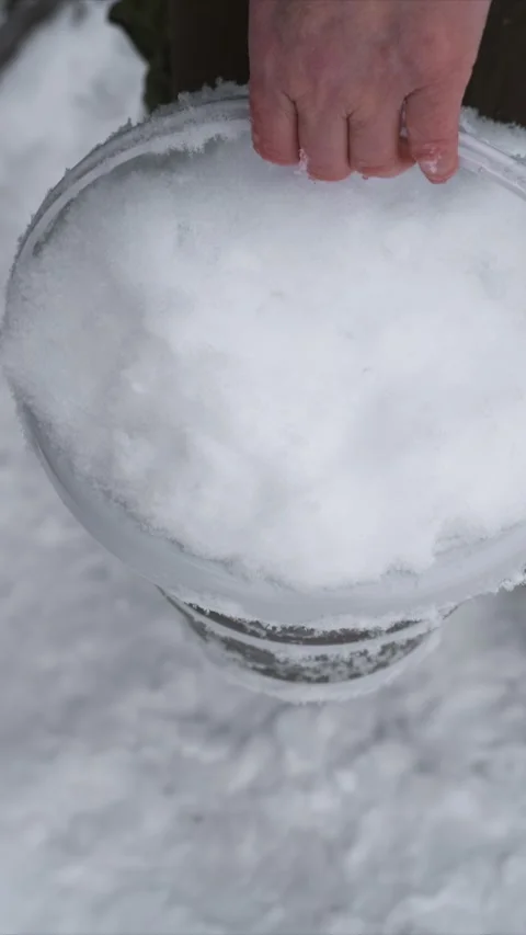 Close up Hand Gripping Snow Filled Plastic Bucket Detail featuring texture white Stock Footage 346788185