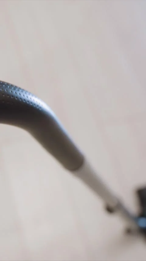 Close up of hand gripping vacuum cleaner handle in motion for domestic cleaning Stock Footage 346786729