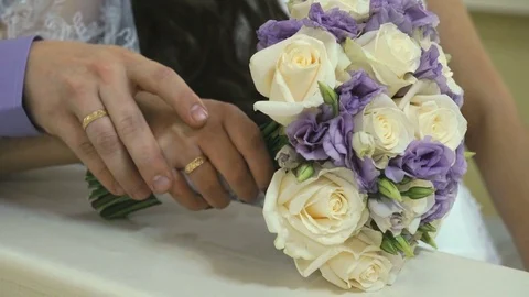 Close-up of hand of groom stroking wife's hand Stock-Footage 80399242