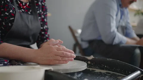 Close-up of the hand of a grumpy woman master works on a potter's wheel in slow Stock Footage 158935978