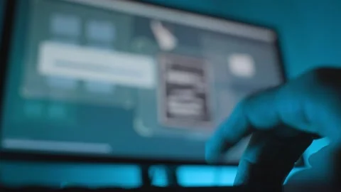 Close up on hand of hacker typing on keyboard as secret files copy on screen Видео 328543352
