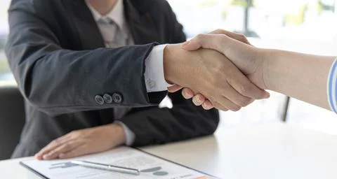 Close-up hand to hand, Congratulations on joining the new employee, Welcome w Stock Photos