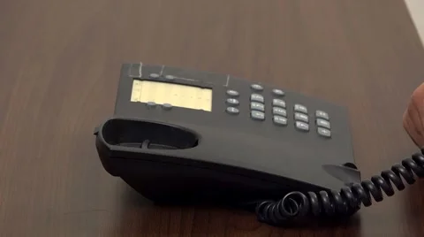 Close up to hand hang down phone receiver, end of conversation  Video stock 46216663