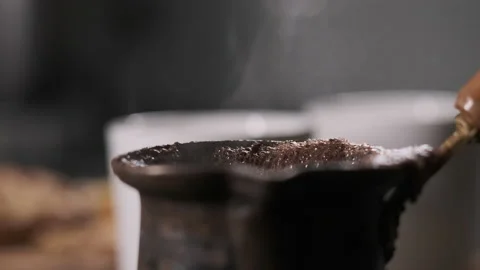 Close up hand held view on steel turk coffee with two white cups on background Stock Footage 148382200
