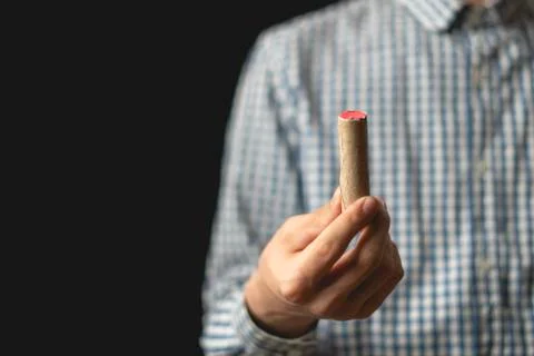 Close up hand hold cracker and fire it on dark background isolated Stock Photos
