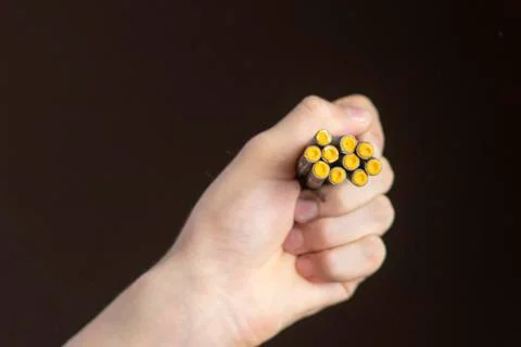 Close up hand hold cracker and fire it on dark background isolated Stock Photos