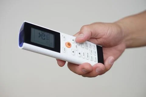 Close up hand hold remote control of air conditioner. Concept, electronics equip Foto stock