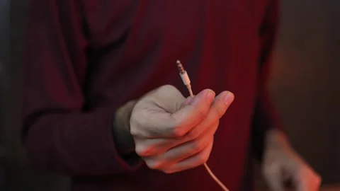 Close Up of Hand Holding 3.5mm Audio Jack Cable Connector Stock Footage 337847322
