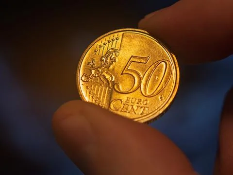 A Close-Up of a Hand Holding a 50 Cent Euro Coin Stock Photos