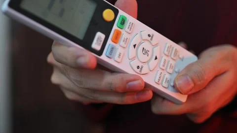 Close Up of Hand Holding Air Conditioner Remote Control Stock Footage 337847310