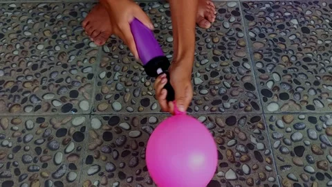 Close up hand holding and pumping a balloon Stock Footage 236371639