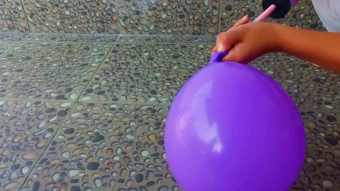 Close up hand holding and pumping a balloon Stock Footage 236372042