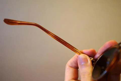 Close up Hand holding back side view of sunglasses Stock Photos