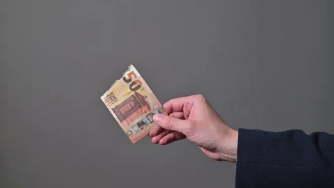 Close-up of hand holding burnt smoking euro banknote Stock Footage 338300033