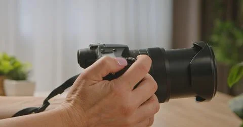 Close Up of a Hand Holding a Camera with Lens Stock Photos