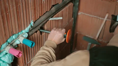 Close up hand holding chisel and hitting hammer. Worker expanding cable grooves Stock Footage 234452855