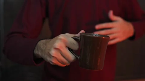 Close Up of Hand Holding Coffee Mug with Blurred Background Video stock 337847317