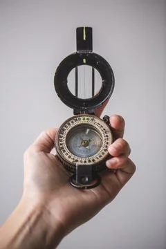Close   up   of   hand   holding   compass Stock Photos