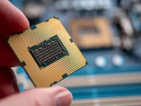 Close-Up of Hand Holding a Computer Processor Chip 写真素材