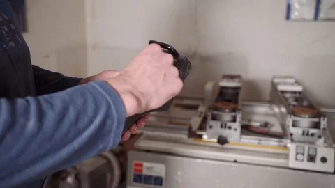 Close-up of a hand holding a control panel in production (factory, factory). CNC Stock Footage 82824077