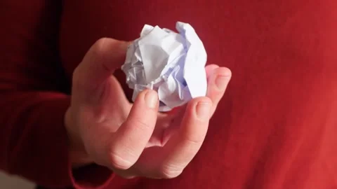 Close up of hand holding crumpled white paper ball Stock Footage 326702363