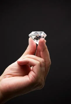 Close up of a hand holding a diamond Stock Photos