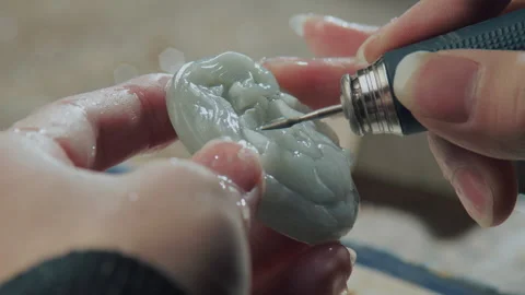 Close up of hand holding electric drill for carving jade, China Stock Footage 140761340