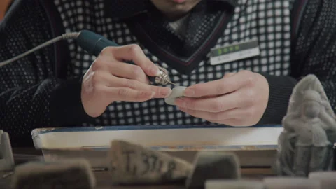 Close up of hand holding electric drill for carving jade, China Video stock 140761559