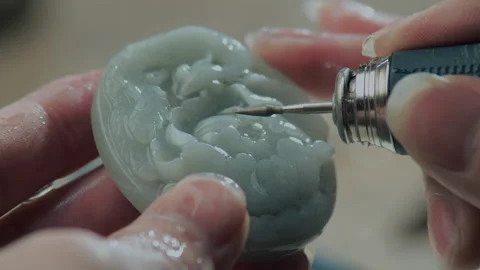 Close up of hand holding electric drill for carving jade, China Video stock 140763189