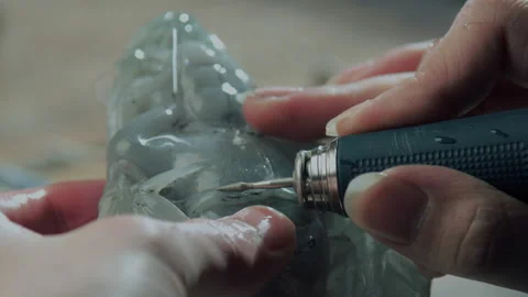 Close up of hand holding electric drill for carving jade, China Stock Footage 140763646