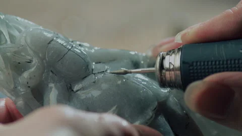 Close up of hand holding electric drill for carving jade, China Stock Footage 140764246