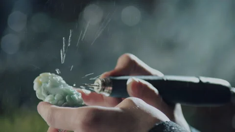 Close up of hand holding electric drill for carving jade, China Stock Footage 140764483