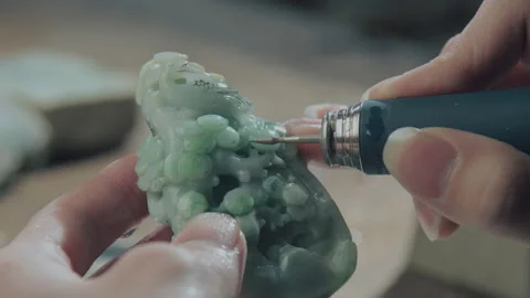 Close up of hand holding electric drill for carving jade, China Stock Footage 140764629