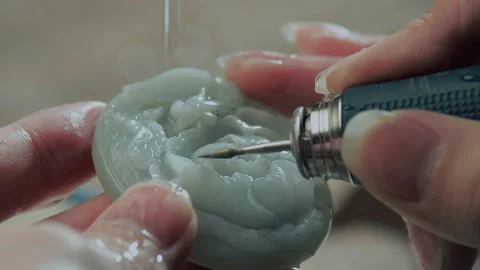 Close up of hand holding electric drill for carving jade, China Stock Footage 140764779