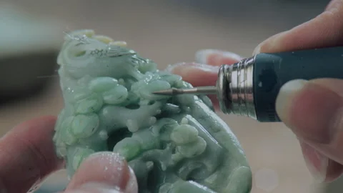 Close up of hand holding electric drill for carving jade, China Stock Footage 140764944