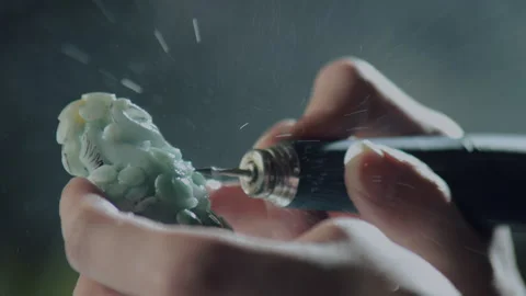 Close up of hand holding electric drill for carving jade, China Stock Footage 140765480