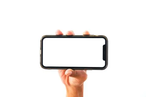 Close-up of a hand holding an empty smartphone screen mockup against a plai.. Stockfoto's