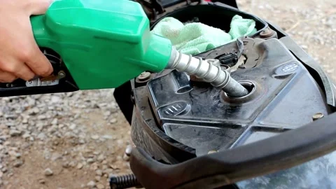 Close up Hand holding faucet atomizer for refueling Process of motor cycle .. Stock Footage 256721248