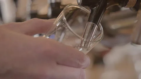 Close-Up of Hand Holding Glass Under Tap Preparing to Pour Drink in Beijing Bar Stock Footage 345755550