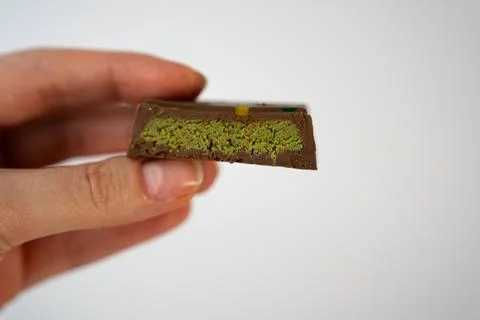 Close-Up Hand Holding Gourmet Pistachio Chocolate Stock Photos