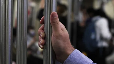 Close up of hand holding on to handrail in subway. Stock Footage 305773609